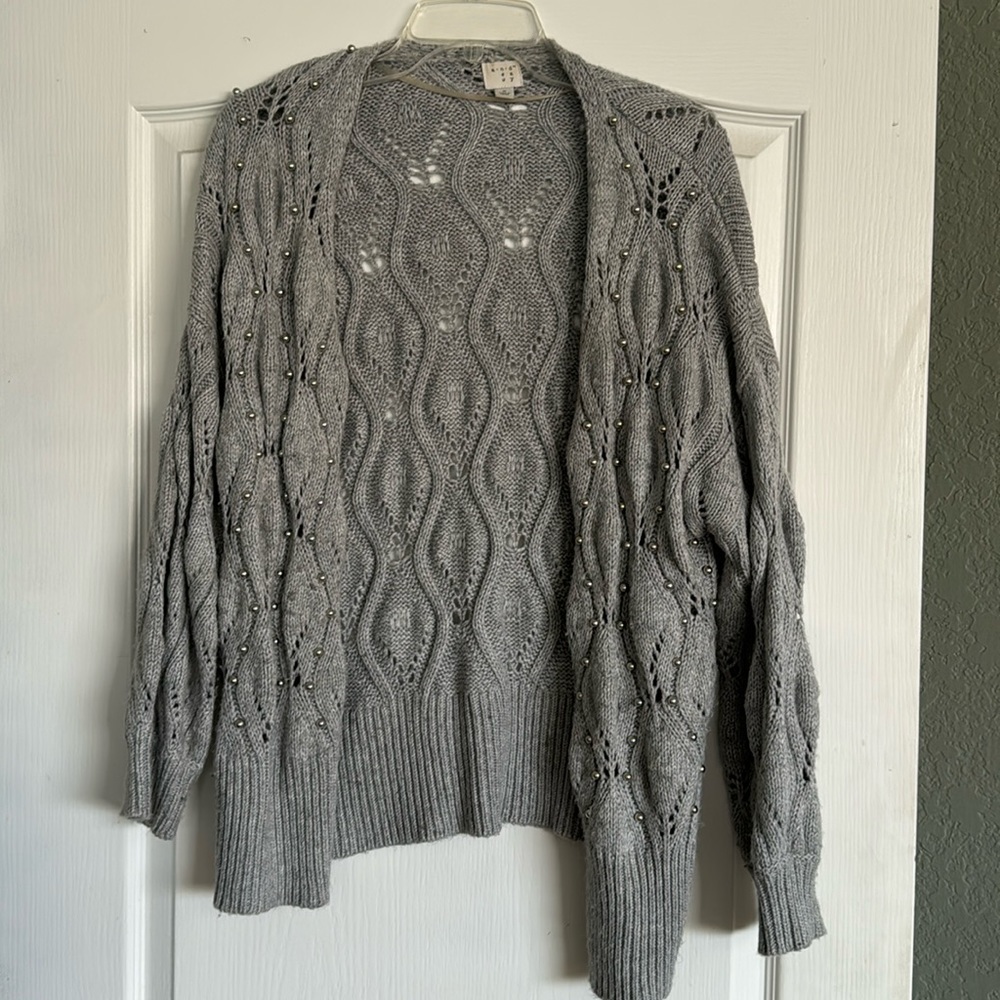 Grey loose knit cardigan with silver balls sewn on throughout.